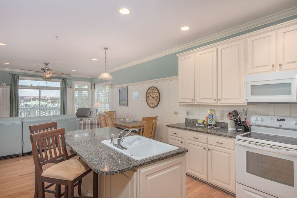 Full kitchen with island seating and granite counters